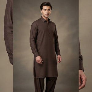Man wearing a brown kurta with pants against a plain background