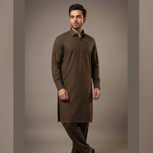 Man wearing a brown kurta against a plain background
