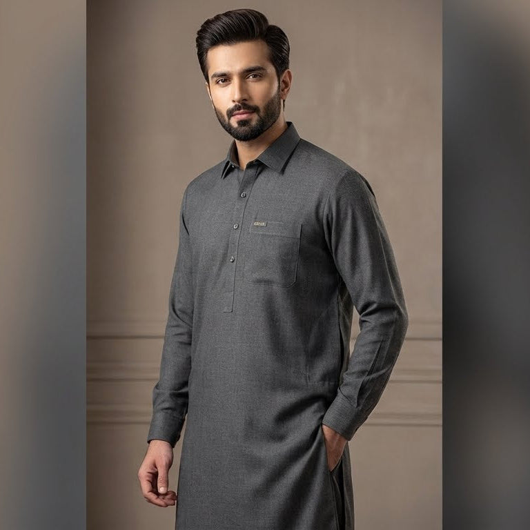 Man wearing a gray long-sleeve shirt against a neutral background