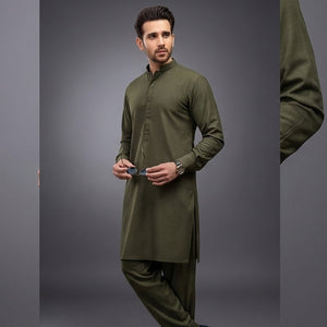 Man wearing a green kurta with pants on a gray background