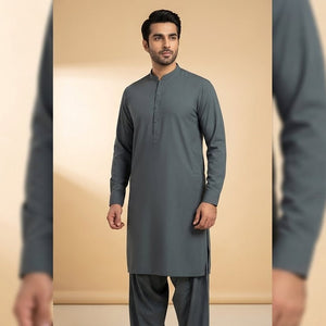 Man wearing a gray kurta with pants against a beige background