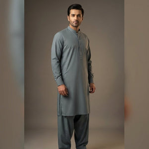 Man wearing a gray kurta with pants against a plain background