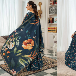 Woman wearing a dark blue floral saree in a living room setting