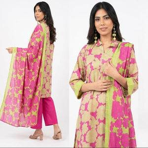 Woman modeling a pink and green traditional outfit on a white background