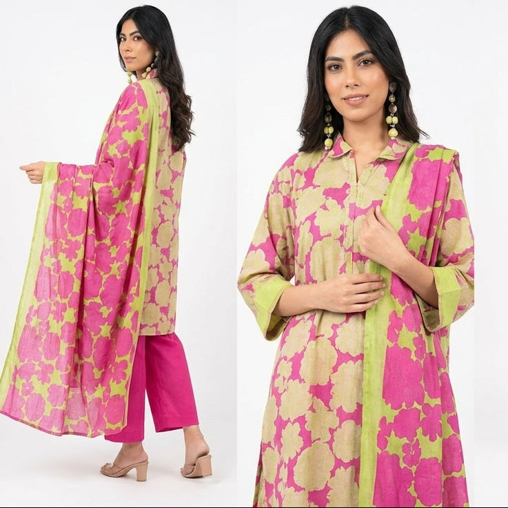 Woman modeling a pink and green traditional outfit on a white background