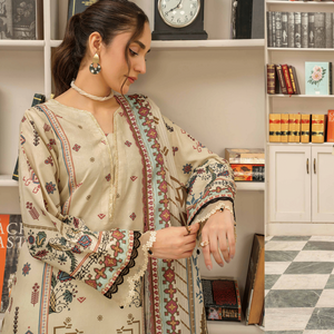 Woman in traditional outfit with floral patterns in a room with bookshelves.
