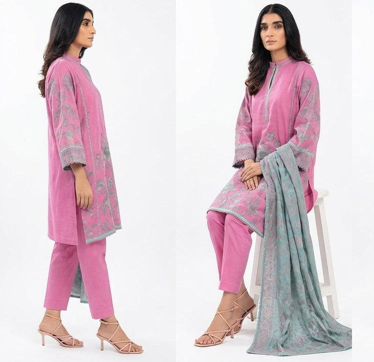 Woman modeling a pink and gray traditional outfit with a scarf on a white background