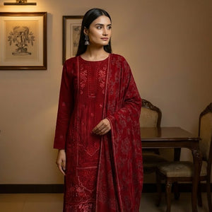 Woman in a red traditional outfit standing in a room with wooden furniture and decor.