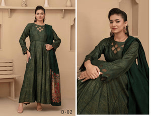 Woman wearing a green traditional outfit with a patterned hem in a neutral setting