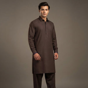 Man wearing a brown kurta with pants on a gray background