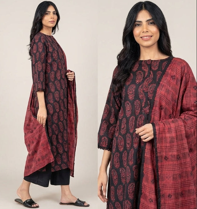 Woman modeling a red and black patterned kurta with black pants against a white background