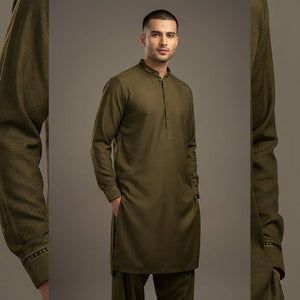 Man wearing an olive green traditional outfit against a gray background