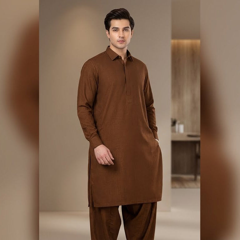 Man wearing a brown kurta with pants in a neutral setting