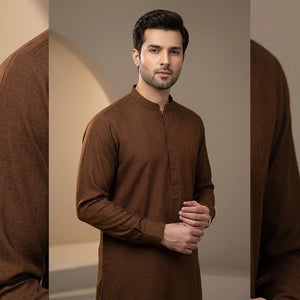 Man wearing a brown kurta against a neutral background