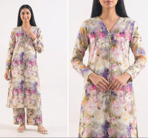 Woman wearing a floral dress with matching pants on a white background