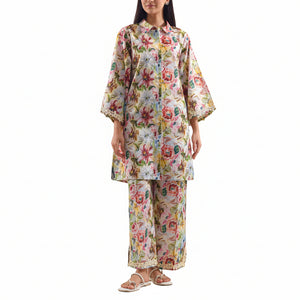 Woman wearing a floral two-piece outfit with Saya branding and product details.