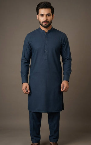Man wearing a blue kurta with brown shoes on a plain background