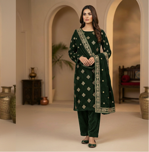 Woman in a green traditional outfit standing in a decorated room with arches and decorative items.