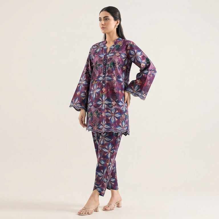 Woman wearing a patterned outfit on a plain background