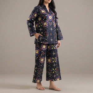 Woman wearing a floral pajama set against a plain background