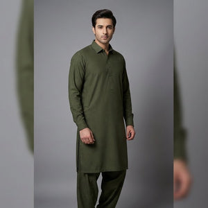 Man wearing a green kurta with pants against a gray background