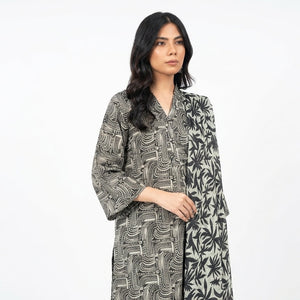 Woman wearing a patterned dress on a white background