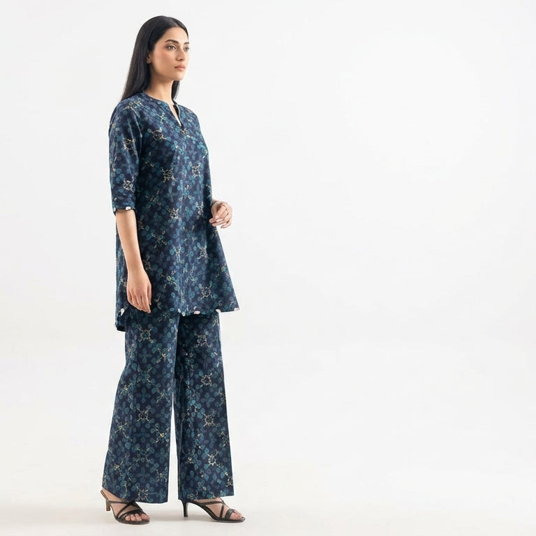 Woman wearing a blue patterned outfit on a white background