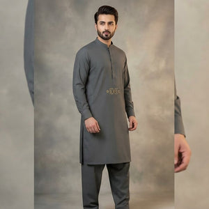 Man wearing a gray kurta with a subtle pattern on a gray background