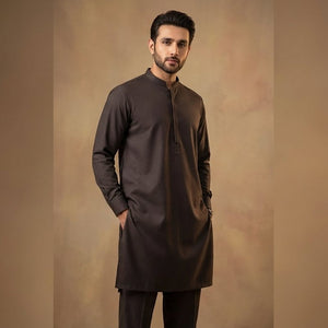 Man wearing a dark brown kurta with pants against a beige background