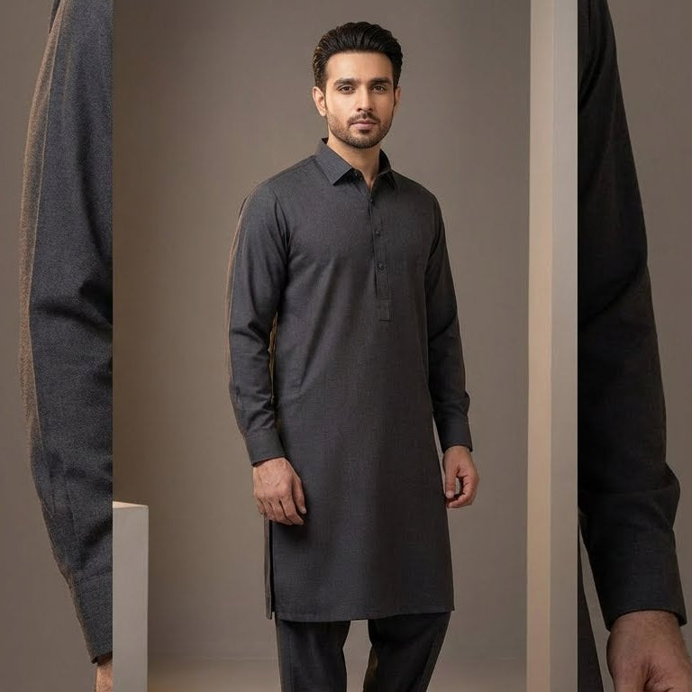 Man wearing a dark gray kurta with black pants against a plain background