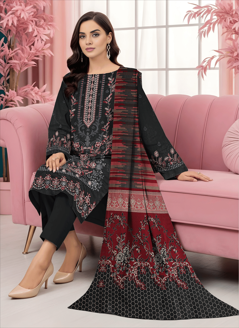 Woman sitting on a pink couch wearing a black and red patterned outfit.