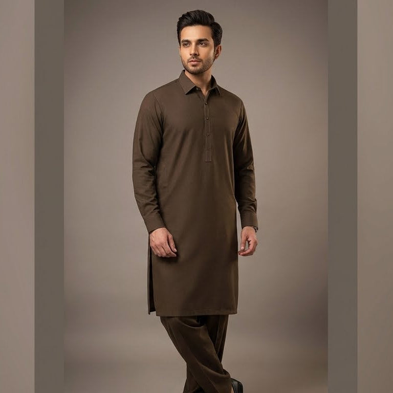 Man wearing a brown kurta against a plain background