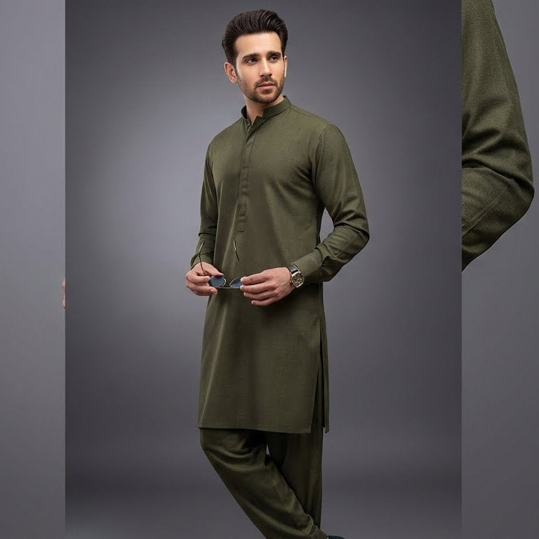 Man wearing a green kurta with pants on a gray background