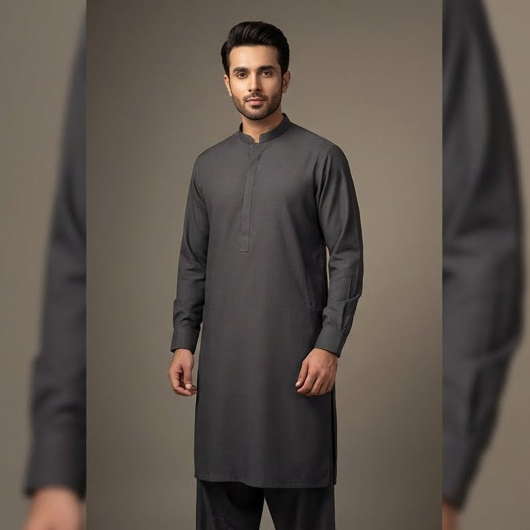 Man wearing a dark gray traditional outfit against a plain background