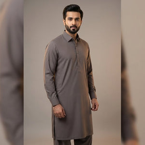 Man wearing a gray kurta against a neutral background