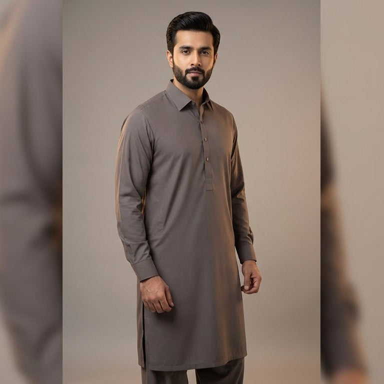 Man wearing a gray kurta against a neutral background