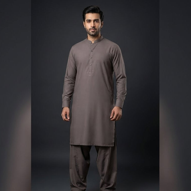 Man wearing a gray traditional outfit on a dark background