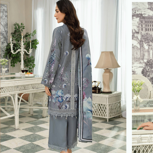 Woman wearing a gray embroidered outfit with a matching shawl in a stylish room.