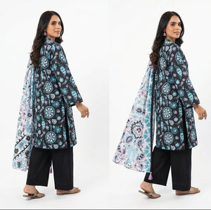 Woman wearing a floral patterned outfit with black pants on a white background