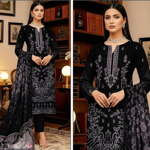 Woman in a black embroidered outfit with 'Nazakat' branding in a room setting.