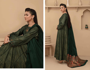 Woman in a green traditional outfit with floral details in a beige room.