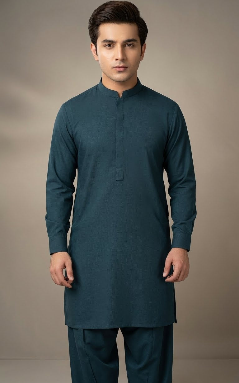 Man wearing a teal kurta with pants against a plain background