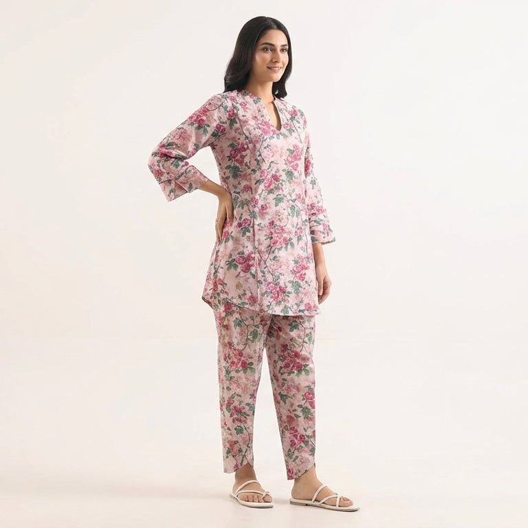 Woman wearing a floral pajama set on a white background
