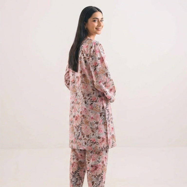 Woman wearing a floral pajama set against a plain background
