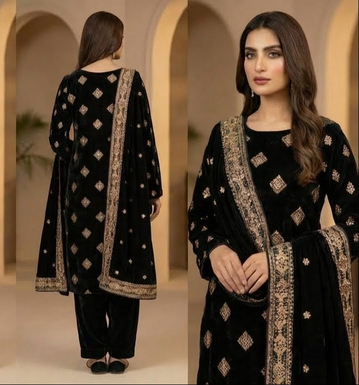 Woman in a black traditional outfit with gold embroidery in a beige archway setting