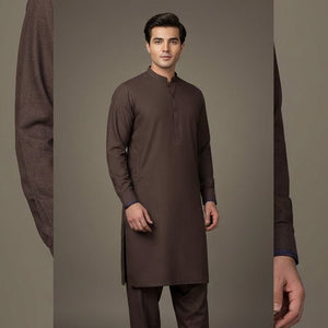 Man wearing a brown kurta with a plain background