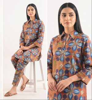 Woman wearing a floral patterned outfit on a white background