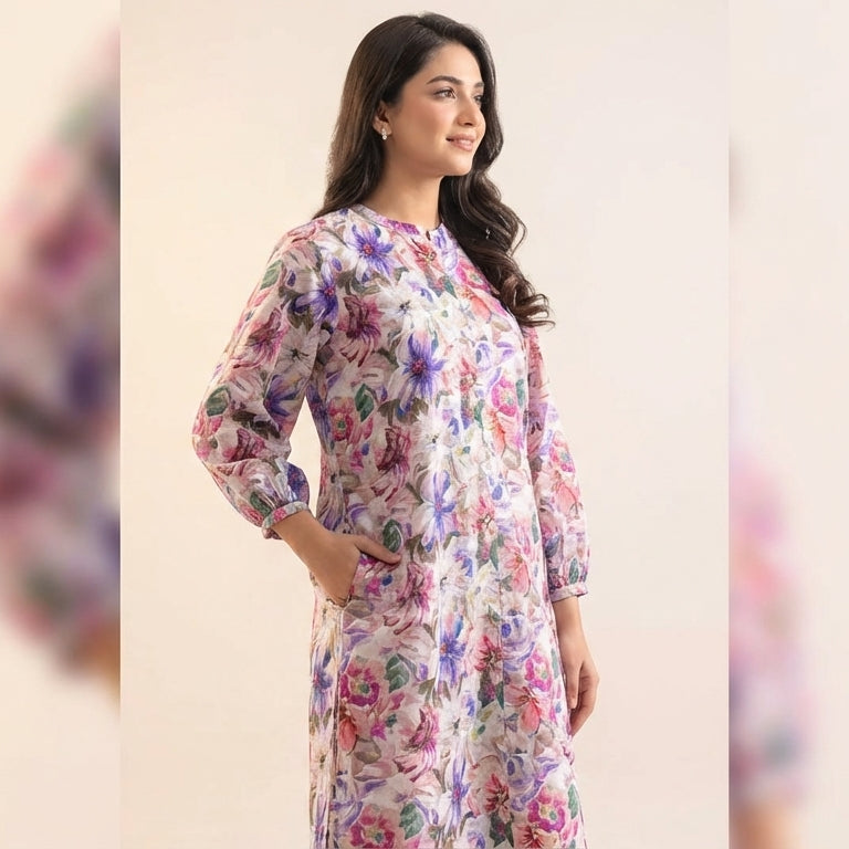 Woman wearing a floral dress against a plain background