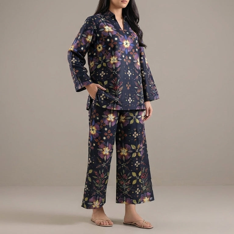 Woman wearing a floral pajama set against a plain background