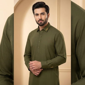 Man wearing a green shirt against a beige background